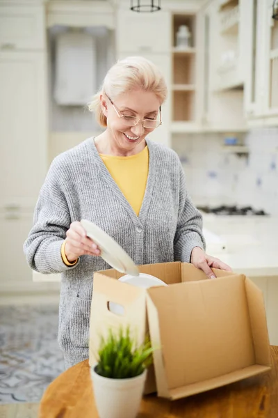 Happy Aged Woman Putting Plates Carton Container While Preparing Relocation — Stock Photo, Image