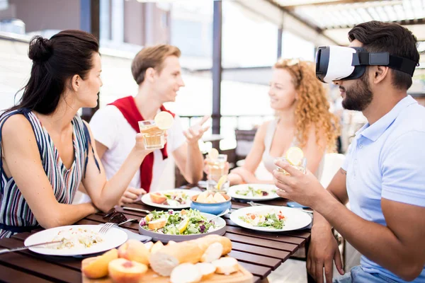 Young Man Headset Sitting Served Table His Talking Friends Watching — 스톡 사진