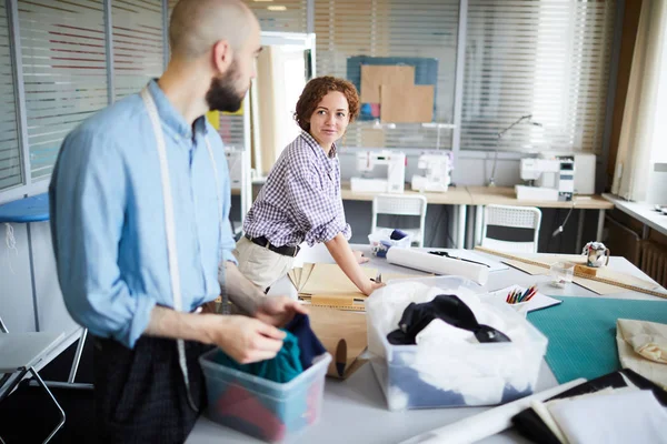 Young Casual Woman Looking Her Colleague While Consulting Him Fabric — Stock Photo, Image
