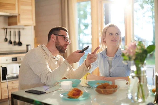 Young Bearded Caucasian Man Pointing While Sitting Kitchen Table His — Stock Photo, Image