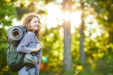Ormanda kamp yeri ararken sırt çantası ile kadın kamp aroung görünümlü