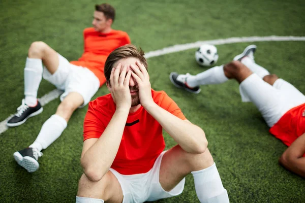 Stressed Tired Footballer Sitting Green Field Covering His Face Hands — Stock Photo, Image