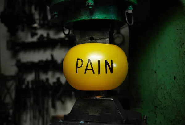 Yellow Ball Symbolizing Pain Situated Two Parts Industrial Machine — Stock Photo, Image