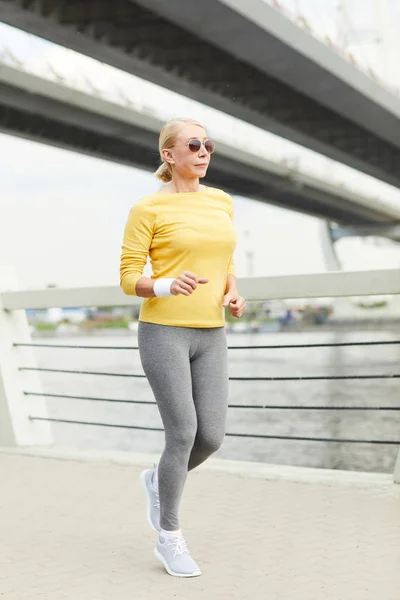 Mature Blond Woman Activewear Running Bridge River Morning — Stok Foto