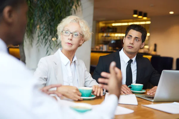 Dwaj Partnerzy Biznesowi Słuchają Uważnie Swoich Kolegów Podczas Spotkania Restauracji — Zdjęcie stockowe