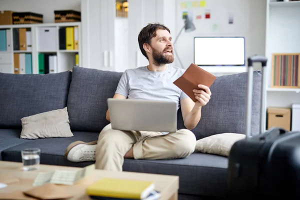 Happy Young Beard Man Passport Reserving Tickets Online While Sitting — Stock Photo, Image