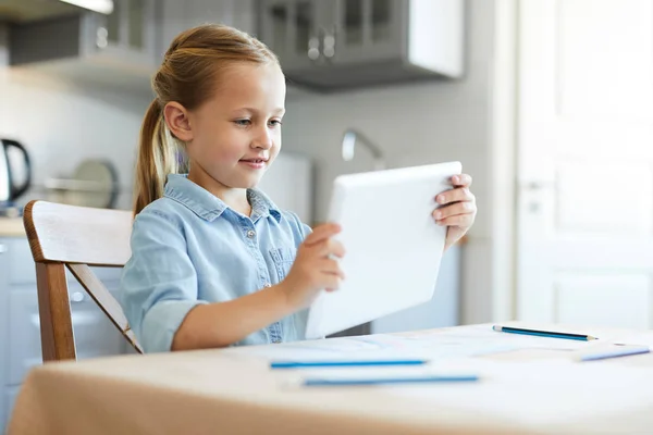 Happy Little Girl Watching Videos Touchpad Screen While Sitting Table — Stock Photo, Image