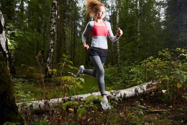 Happy Young Sportswoman Running Birch Log While Moving Forest Path — Stock Photo, Image