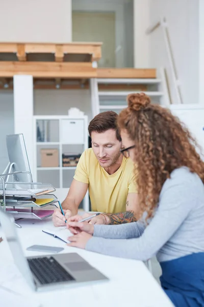 Zwei Junge Designer Betrachten Ihre Arbeitsnotizen Und Diskutieren Sie Beim — Stockfoto