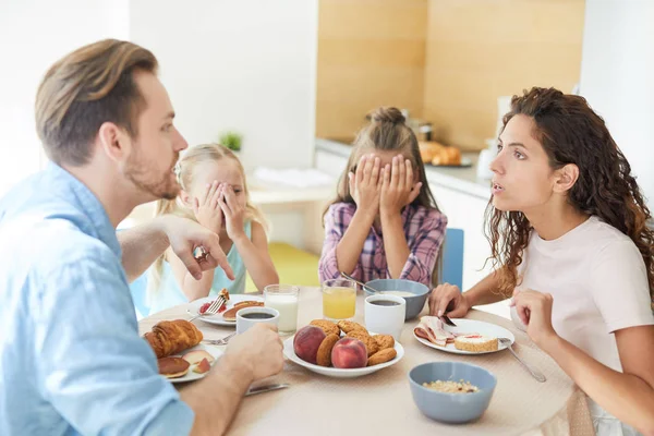 Young Annoyed Couple Having Argument Breakfast While Daughters Sitting Covering — 스톡 사진