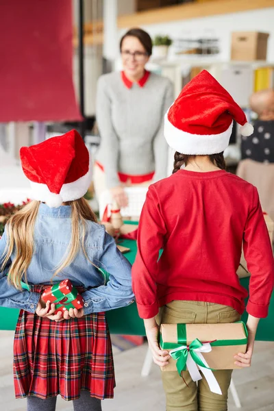 Santa Kapaklar Iki Küçük Kız Arkalarında Anneleri Için Xmas Hediyeler — Stok fotoğraf