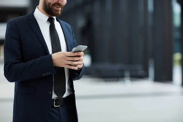 Elegant Businessman Messaging Smartphone While Standing Modern Building — Stock Photo, Image
