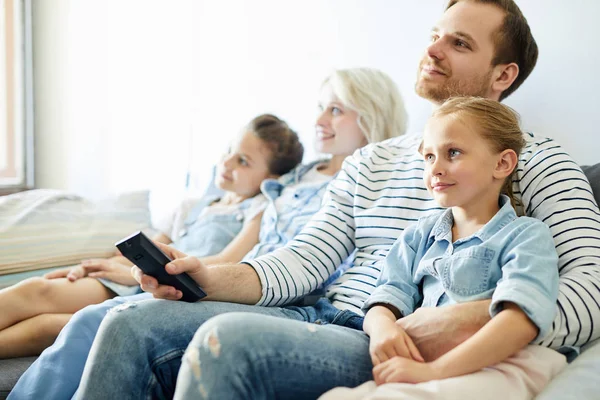 Young Family Parents Two Little Daughters Sitting Sofa Watching — Stock Photo, Image