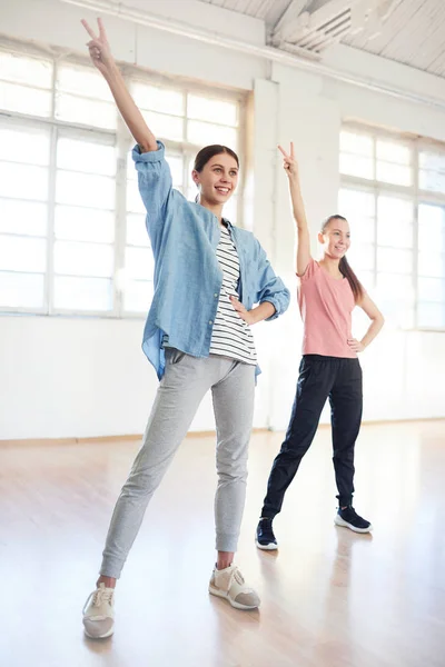 Happy Young Active Females Raising Hands While Repeating Coach Studio — Stock Photo, Image