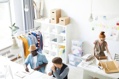 Moda ve stil stüdyosunda çalışan genç çağdaş tasarımcılar grubu