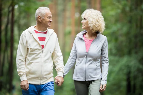 Active Senior Spouses Sportswear Holding Hands While Walking Park Forest — Stock Photo, Image