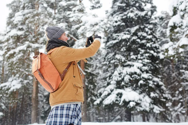 Positive Curious Young Man Winter Coat Wearing Satchel Using Smarphone — Stock Photo, Image