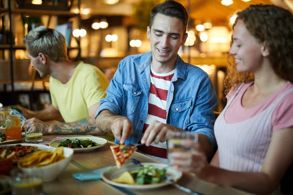 Joven Hombre Poniendo Rebanada Pizza Plato Girlfrind Mientras Cuida Cena — Foto de Stock