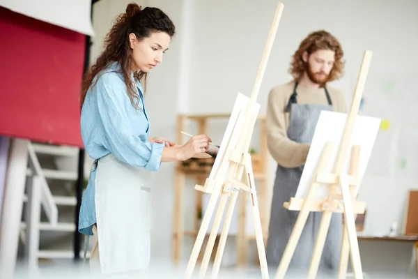 Serious Girl Her Colleague Workwear Standing Front Easels Painting Lesson — Stock Photo, Image