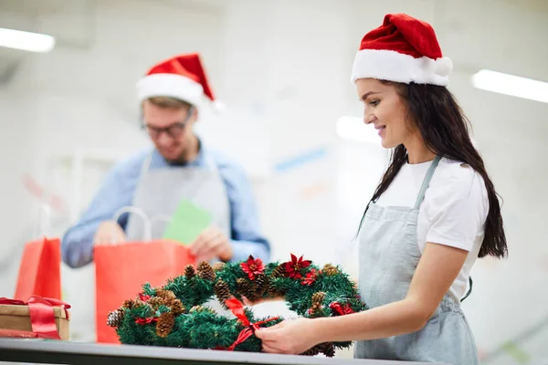 Content Attractive Female Florist Apron Santa Hat Looking Her Work — Stock Photo, Image