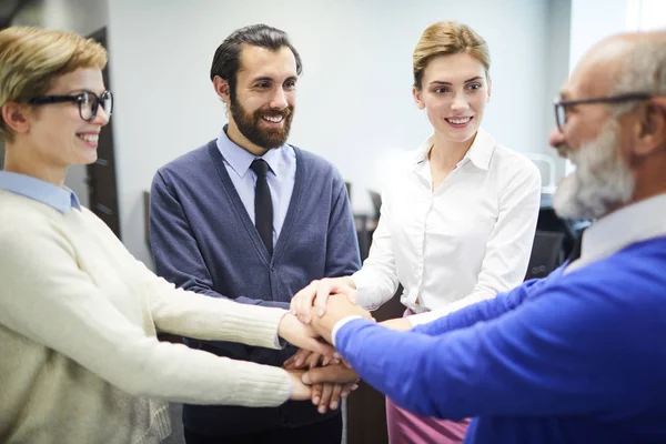 Cheerful Young Colleagues Looking Aged Director While Making Pile Hands — Stock Photo, Image