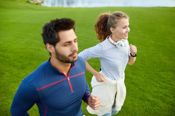 Young Sportswoman Her Boyfriend Running Green Field Morning Training — Stock Photo, Image