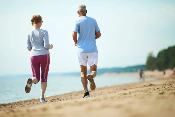 Rückansicht Eines Älteren Ehepaares Aktivkleidung Das Entlang Der Küste Sandstrand — Stockfoto