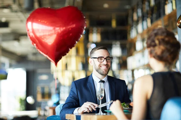 バレンタインデーのレストランで昼食中に彼のガールフレンドを見て幸せな若い男 — ストック写真