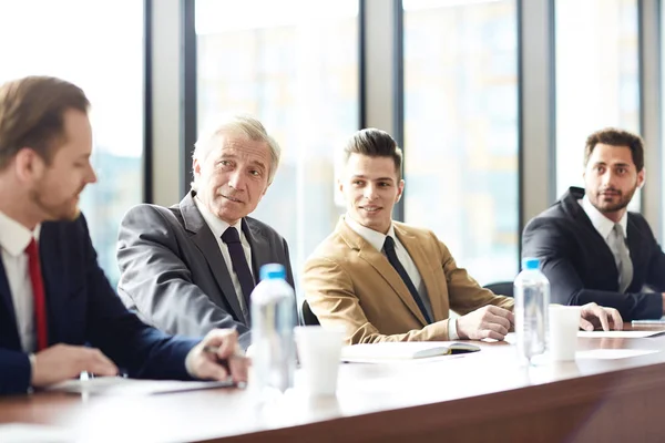 Content Confident Businessmen Different Ages Discussing Company Development Sitting Table — Stock Photo, Image