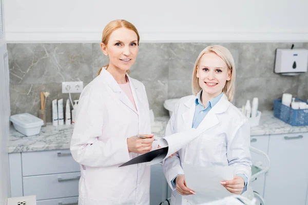 Two Successful Clinicians Uniform Looking Camera While Working Medical Papers — Stock Photo, Image