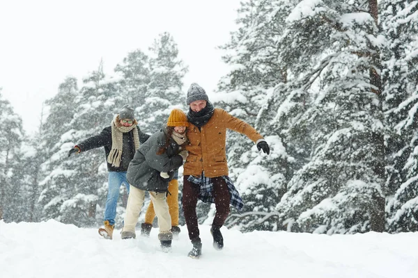 Positive Excited Young Friends Warm Clothing Running Winter Hill While — Stock Photo, Image