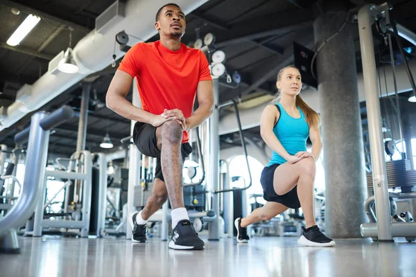 Two Athletes Activewear Doing Exercise Stretching Legs While Repeating Coach — Stock Photo, Image