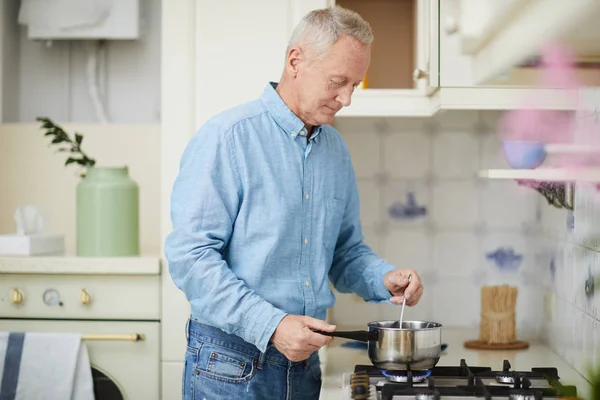Senior Man Mixing Something Pan While Standing Gas Stove Cooking — Stock Photo, Image