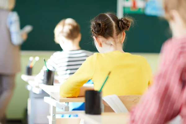 Rear View School Students Casual Clothing Sitting Desks Writing Workbooks — Stock Photo, Image