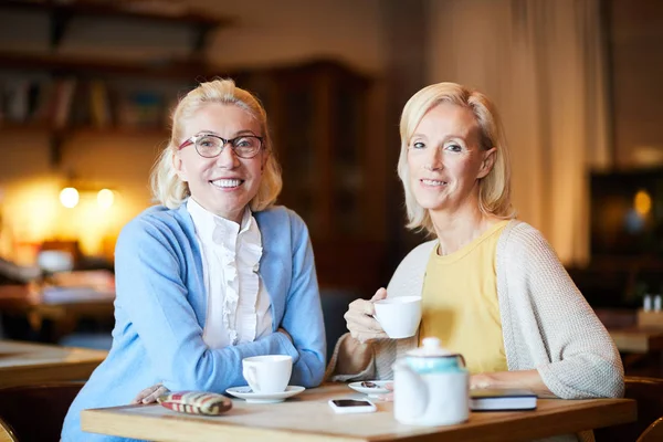 Two Mature Females Smart Casual Looking You While Spending Time — Stock Photo, Image