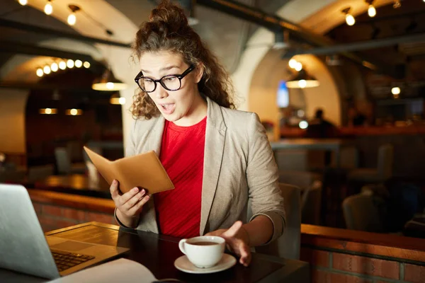 Young Amazed Businesswoman Looking Bill Price Her Order While Sitting — ストック写真