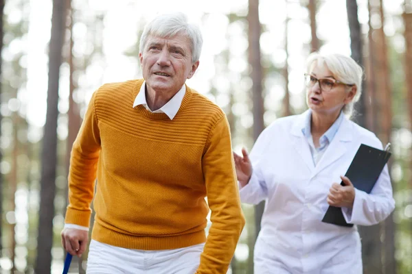 Serious Concentrated Senior Man Yellow Sweater Using Walking Stick While — Stock Photo, Image