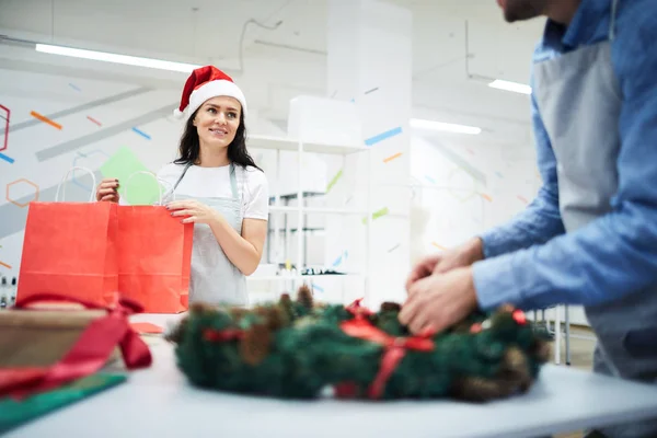 Positive Creative Designers Working Christmas Decorations Studio Packing Gifts Illuminated — Stock Photo, Image