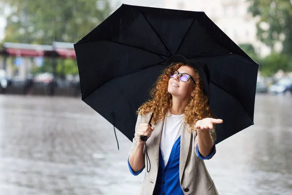 Happy Girl Looking Upwards Her Black Umbrella While Enjoying Rain — Stock Photo, Image