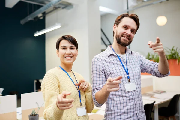 Young Cheerful Office Managers Badges Pointing You Front Camera Smiling — Stock Photo, Image