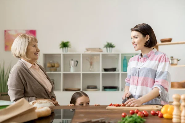 Dos Mujeres Casuales Conversando Cocina Mientras Una Más Joven Corta — Foto de Stock