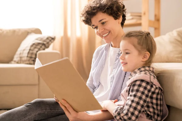 Young Cheerful Mother Her Cute Diligent Daughter Looking Page Book — Stock Photo, Image