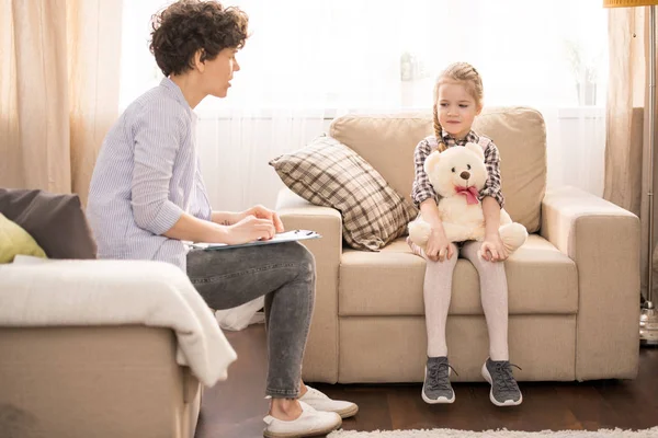 Young Female Tutor Casualwear Sitting Armchair Front Little Girl While — Stock Photo, Image