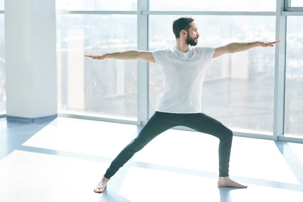 Young Man Black Leggins White Shirt Stretching One Leg While — ストック写真