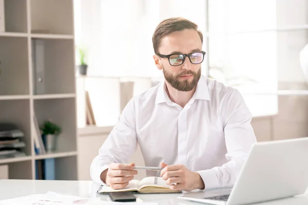 Jonge Bebaarde Zakenman Bril Wit Shirt Zoek Naar Laptop Display — Stockfoto