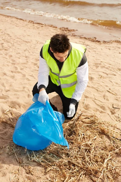 Młody Współczesny Wolontariusz Mundurze Zbierający Odpady Podczas Pracy Piaszczystej Plaży — Zdjęcie stockowe