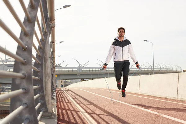 Active Caucasian Sportsman Skipping Rope Exercising Racetrack Modern Stadium Sunny — Stock Photo, Image