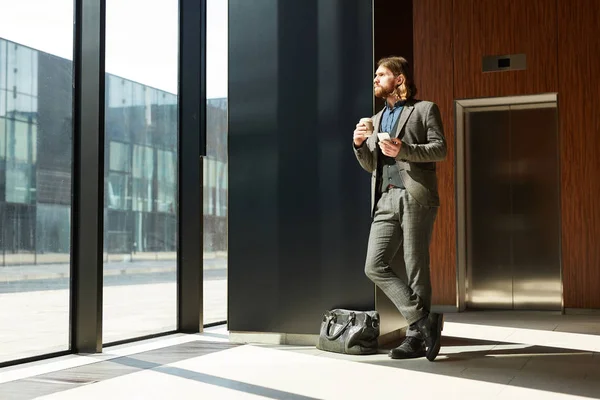 Young Businessman Formalwear Having Drink Texting Smartphone While Looking Airport — 스톡 사진