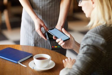 Kafe veya restoranda içki ve yiyecek için mobil uygulama ile ödeme akıllı telefon ile Çağdaş mobil iş kadını