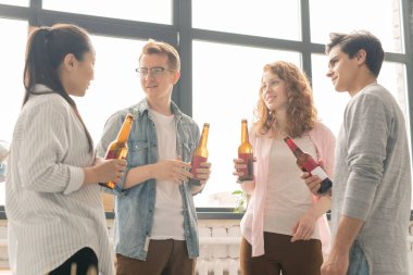 Bira bira ile iki genç kültürlerarası çiftler bir içki için toplandıktan sonra akşam ne yapacağını tartışıyor
